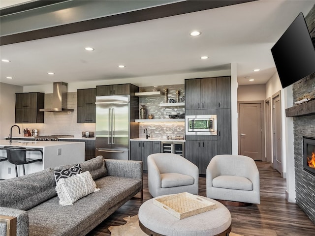 184 Caravelle Dr Unit 20, Keystone, CO 80435 - living room with a stone fireplace, wet bar, dark wood finished floors, recessed lighting, and wine cooler
