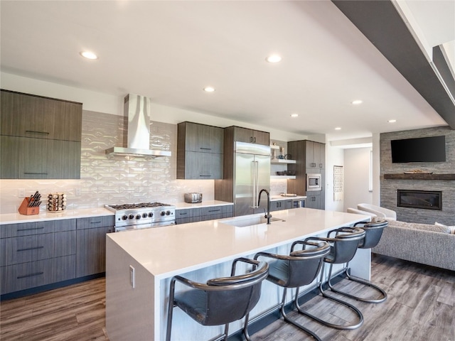 184 Caravelle Dr Unit 20, Keystone, CO 80435 - kitchen with wall chimney exhaust hood, built in appliances, dark wood finished floors, modern cabinets, and recessed lighting