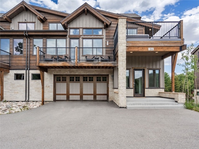 184 Caravelle Dr Unit 20, Keystone, CO 80435 - view of front of house featuring a balcony, asphalt driveway, a garage, and stone siding