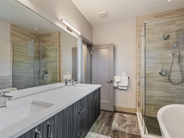 184 Caravelle Dr Unit 20, Keystone, CO 80435 - full bath featuring a shower stall, double vanity, wood tiled floors, and a soaking tub