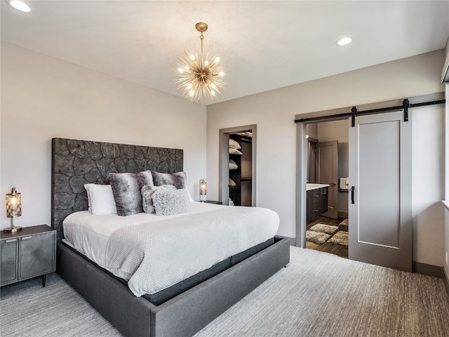 184 Caravelle Dr Unit 20, Keystone, CO 80435 - bedroom with a barn door, a chandelier, recessed lighting, a spacious closet, and connected bathroom