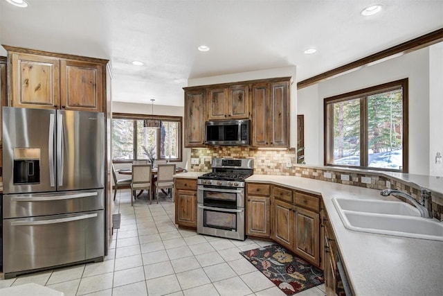 120 Windwood Cir, Breckenridge, CO 80424 - kitchen with backsplash, light countertops, light tile patterned floors, a sink, and appliances with stainless steel finishes