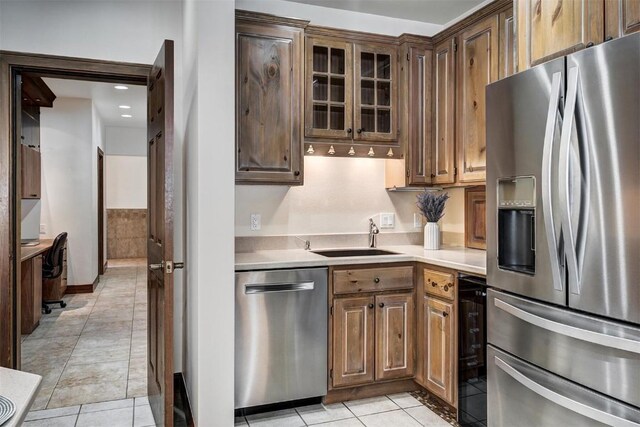 120 Windwood Cir, Breckenridge, CO 80424 - kitchen with a sink, light tile patterned floors, glass insert cabinets, stainless steel appliances, and light countertops