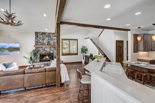 120 Windwood Cir, Breckenridge, CO 80424 - living room featuring dark wood-style flooring, baseboards, recessed lighting, stairs, and a fireplace