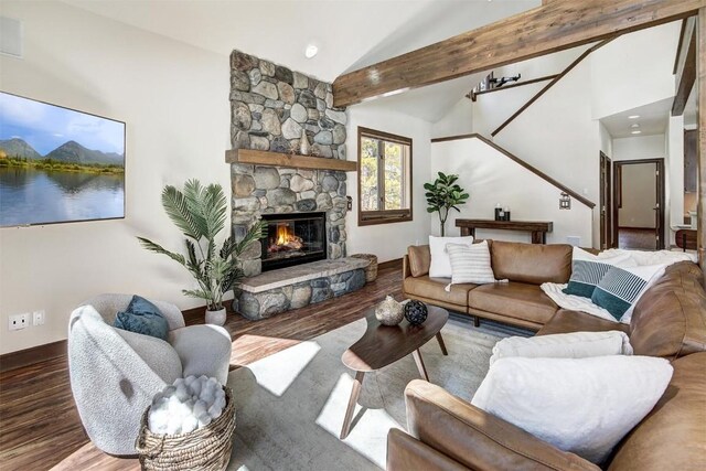 120 Windwood Cir, Breckenridge, CO 80424 - living room featuring vaulted ceiling, a stone fireplace, baseboards, and wood finished floors