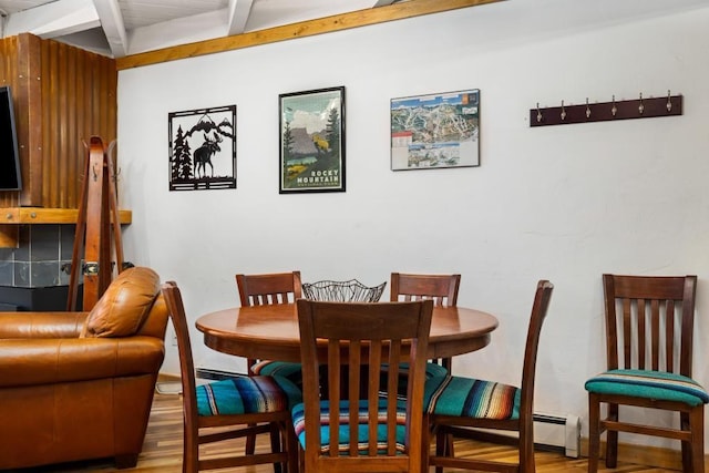 dining space featuring hardwood / wood-style flooring and beamed ceiling