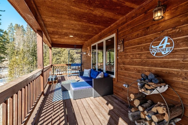 wooden terrace featuring an outdoor living space