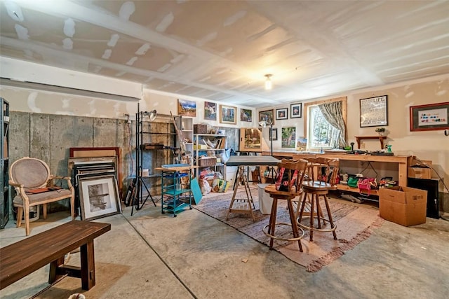 interior space featuring concrete flooring and a workshop area
