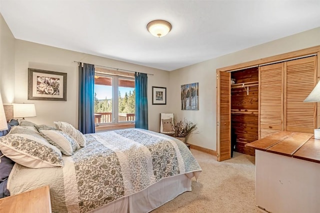 bedroom with baseboards, a closet, and light colored carpet
