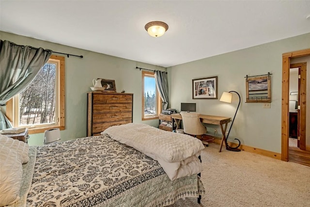 carpeted bedroom with baseboards and multiple windows
