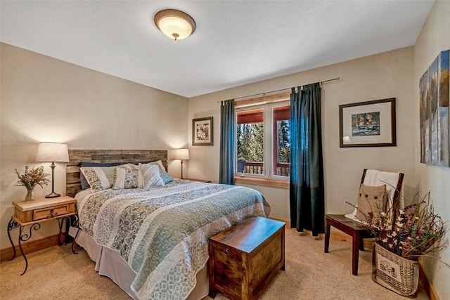 bedroom featuring baseboards and light carpet