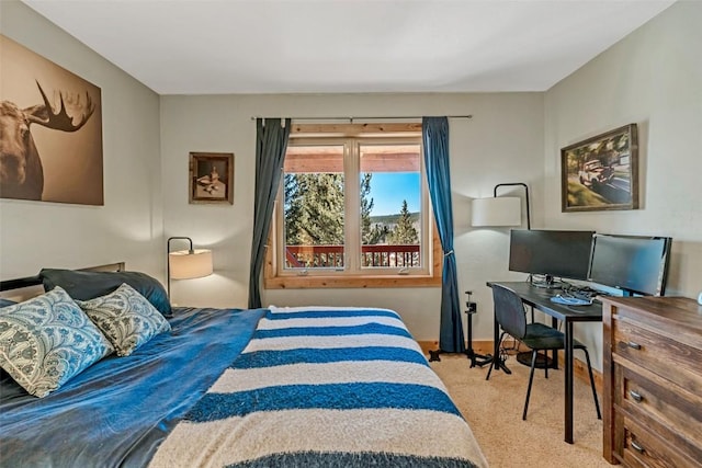 bedroom featuring carpet and baseboards