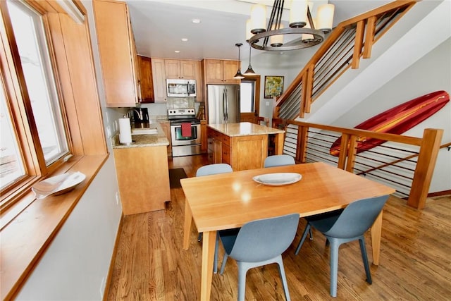 115 Beeler Pl Unit 1, Copper Mountain, CO 80443 - dining room featuring a chandelier, light wood-style floors, stairway, and recessed lighting