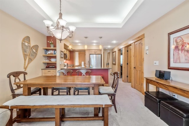 dining space with light carpet and a chandelier