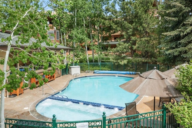 2720 Eagleridge Dr Unit 207, Steamboat Springs, CO 80487 - view of swimming pool with a patio, a pool with connected hot tub, and view of wooded area