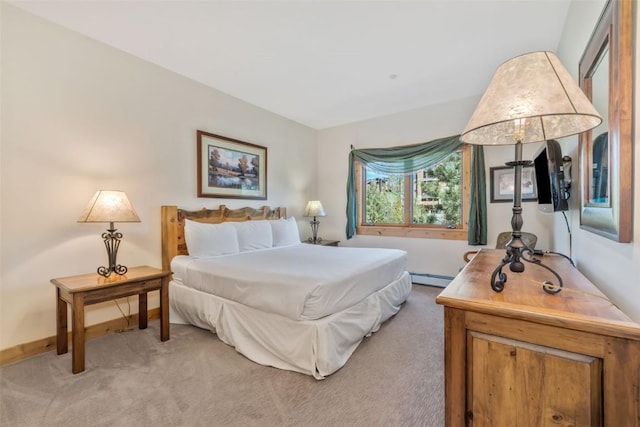 bedroom with light colored carpet, a baseboard heating unit, and baseboards