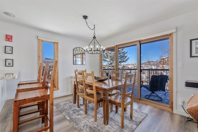 dining room featuring an inviting chandelier and wood finished floors