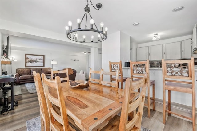 dining space with an inviting chandelier and light wood-style floors