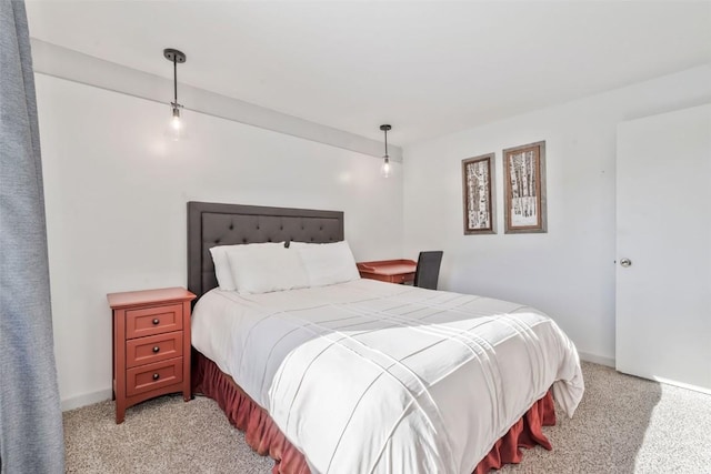 bedroom featuring light colored carpet and baseboards