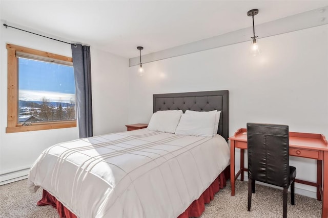 bedroom with baseboard heating and carpet