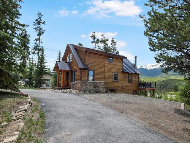 511 Fairview Blvd, Breckenridge, CO 80424 - view of property exterior with a metal roof, asphalt driveway, a mountain view, and stone siding