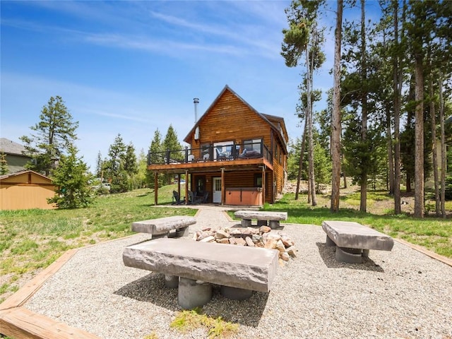 511 Fairview Blvd, Breckenridge, CO 80424 - back of house featuring a hot tub, a wooden deck, and a lawn