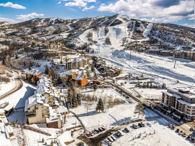 snowy aerial view with a mountain view