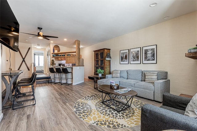 living room with hardwood / wood-style floors and ceiling fan