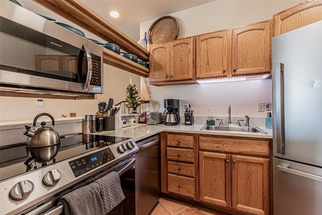 kitchen featuring sink, light tile patterned floors, and appliances with stainless steel finishes