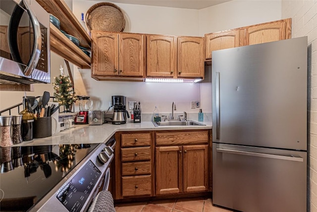 kitchen featuring light tile patterned floors, sink, and appliances with stainless steel finishes