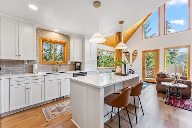 1375 Roberts Rd, Alma, CO 80440 - kitchen featuring healthy amount of natural light, a kitchen breakfast bar, white cabinetry, light countertops, and lofted ceiling
