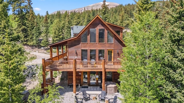 1375 Roberts Rd, Alma, CO 80440 - back of property with a wooded view, a patio area, a deck with mountain view, and driveway