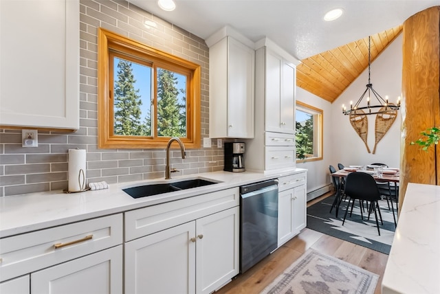1375 Roberts Rd, Alma, CO 80440 - kitchen with stainless steel dishwasher, lofted ceiling, white cabinetry, a chandelier, and backsplash