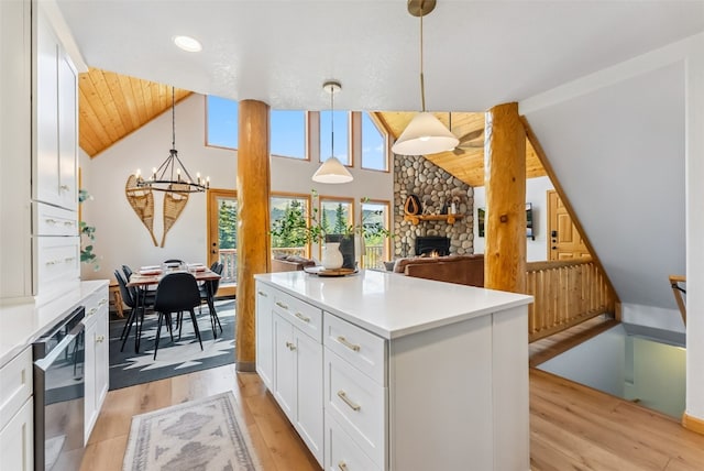 1375 Roberts Rd, Alma, CO 80440 - kitchen with a chandelier, white cabinetry, a fireplace, light wood finished floors, and light countertops