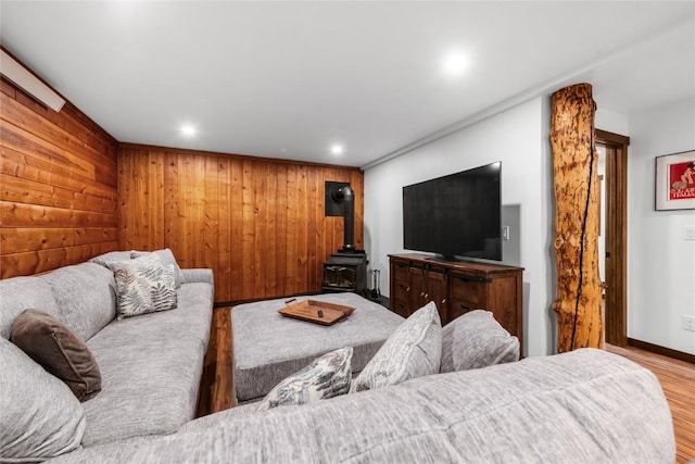 26395 County Road 33a, Steamboat Springs, CO 80487 - living area featuring wood finished floors, a wood stove, wooden walls, recessed lighting, and baseboards