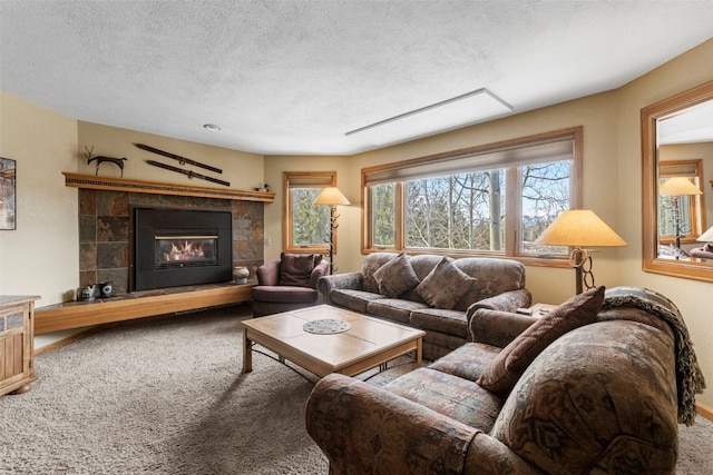 living area with carpet flooring, a fireplace, and a textured ceiling