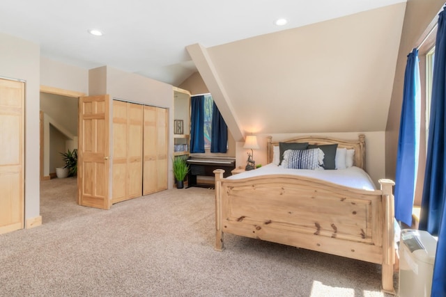 bedroom featuring recessed lighting, lofted ceiling, a closet, and light carpet