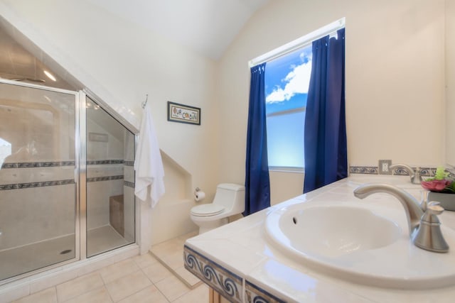 bathroom featuring a sink, toilet, a stall shower, lofted ceiling, and tile patterned flooring