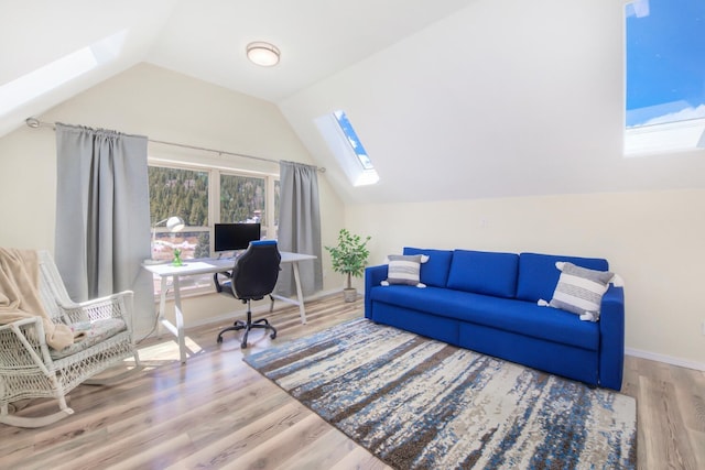 office space featuring baseboards, wood finished floors, and lofted ceiling with skylight