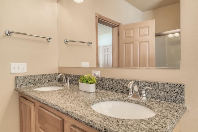 bathroom with a sink and double vanity