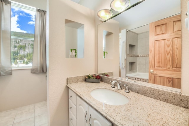 full bath featuring tile patterned flooring, vanity, and bathing tub / shower combination