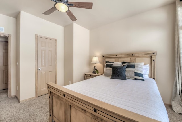 bedroom featuring visible vents, a ceiling fan, and light colored carpet