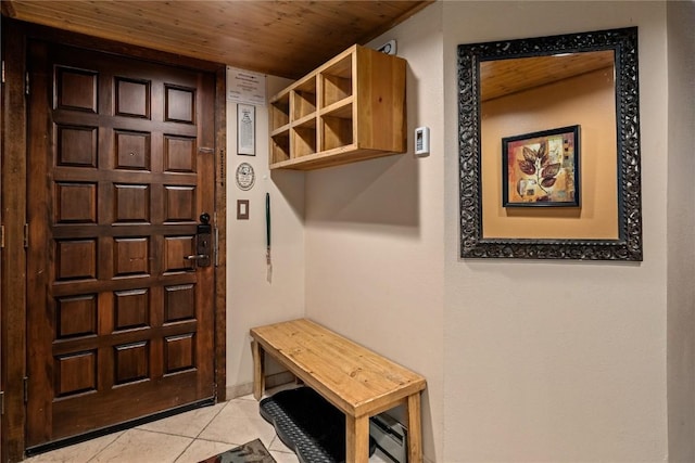 mudroom with light tile patterned floors and wooden ceiling