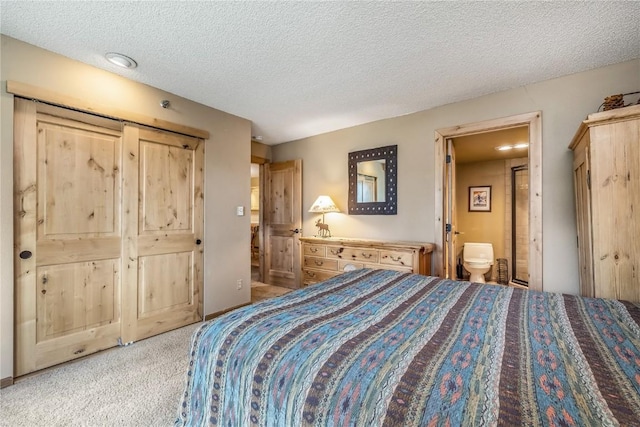 530 S French St Unit 110, Breckenridge, CO 80424 - bedroom with light colored carpet, a textured ceiling, and ensuite bath