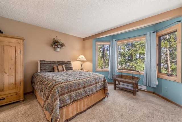 530 S French St Unit 110, Breckenridge, CO 80424 - bedroom featuring light colored carpet, a textured ceiling, baseboard heating, and baseboards