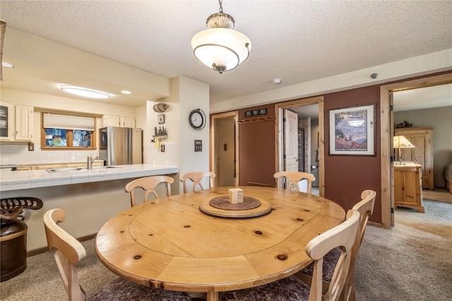 530 S French St Unit 110, Breckenridge, CO 80424 - dining area featuring light carpet, a textured ceiling, and baseboards