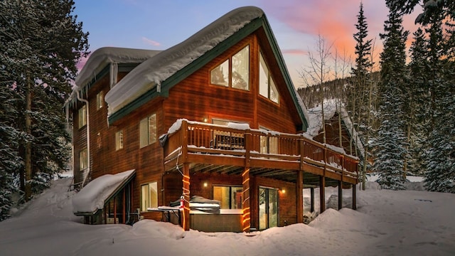 285 Davis Ct, Blue River, CO 80424 - view of snow covered exterior featuring a wooden deck and a hot tub