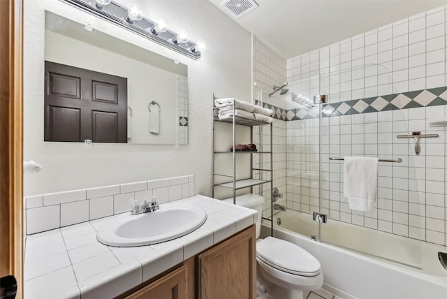 285 Davis Ct, Blue River, CO 80424 - bathroom featuring toilet, enclosed tub / shower combo, backsplash, vanity, and a textured wall