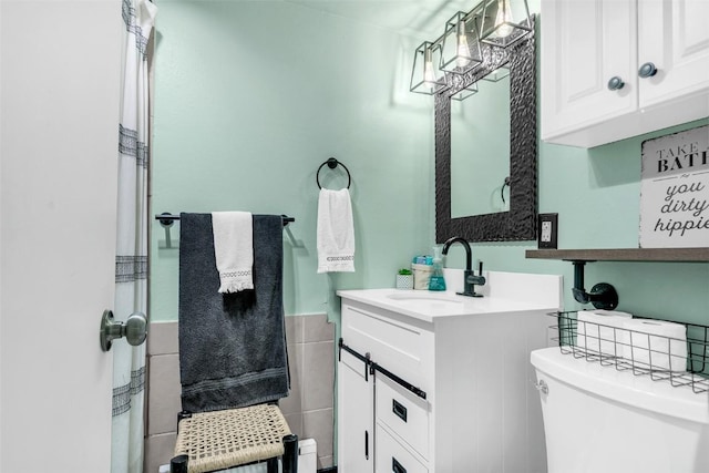136 Lance Ln Unit 2, Breckenridge, CO 80424 - bathroom featuring vanity, tile walls, and a wainscoted wall