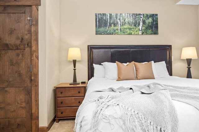 bedroom featuring carpet floors and baseboards
